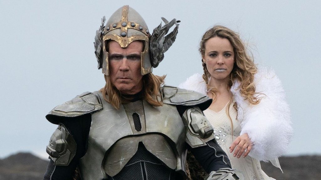 Still from the song Eurovision Song Contest, a man dressed in a Viking costume walking toward the camera with a woman in a white dress behind him