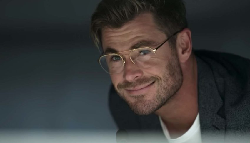 Still from Spiderhead (2022), close up shot of Chris Hemsworth's smiling face